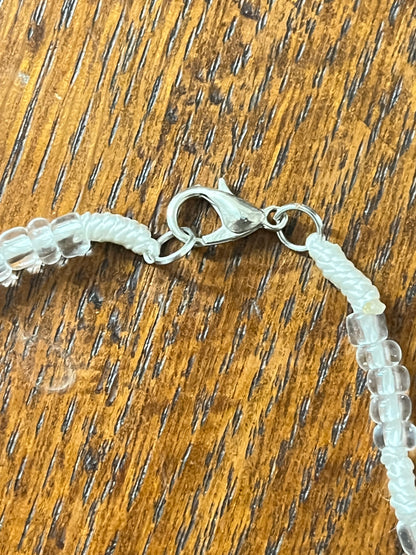 White Rosary in a Glass Bottle